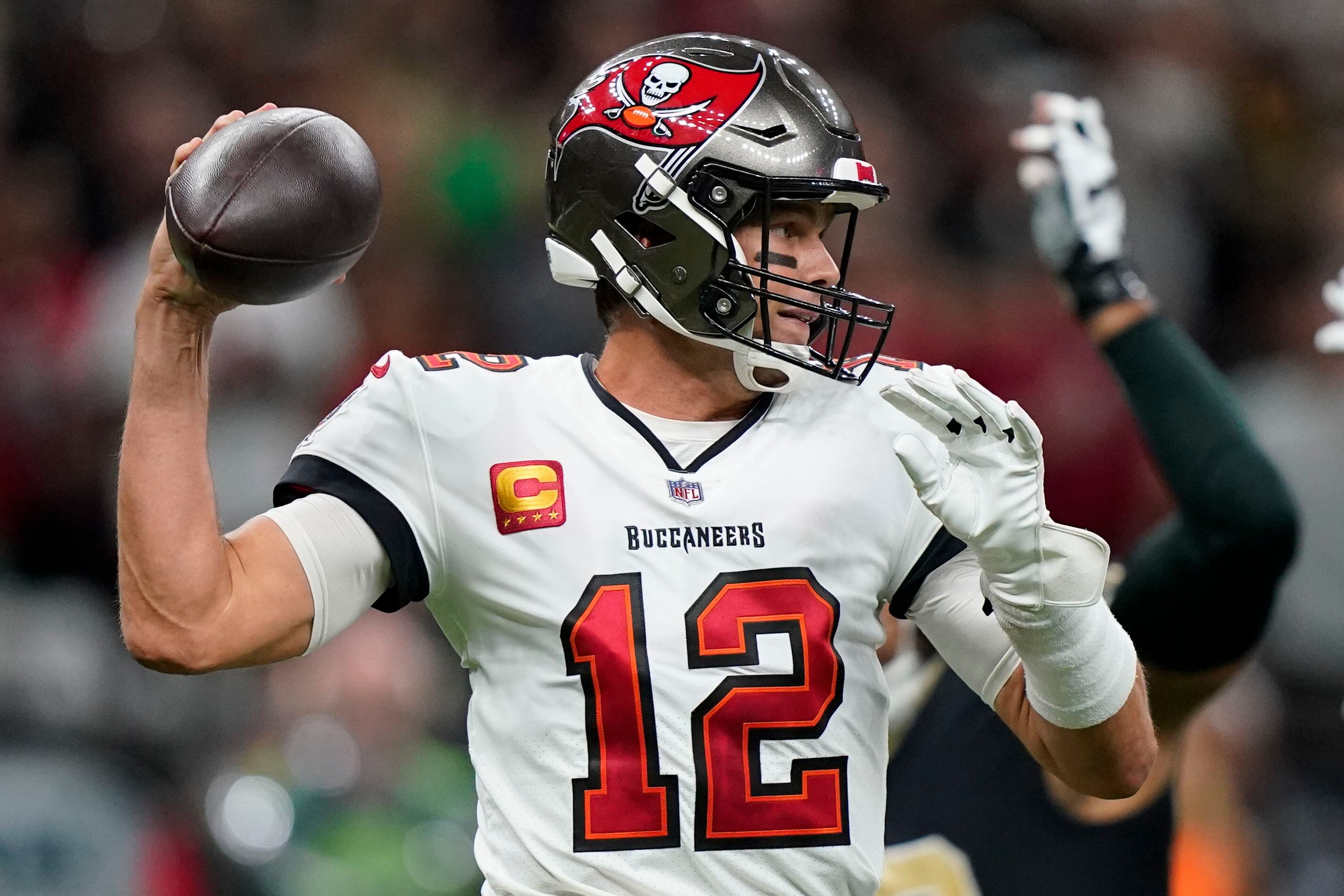 Tampa Bay Buccaneers running back Leonard Fournette (left) shoves