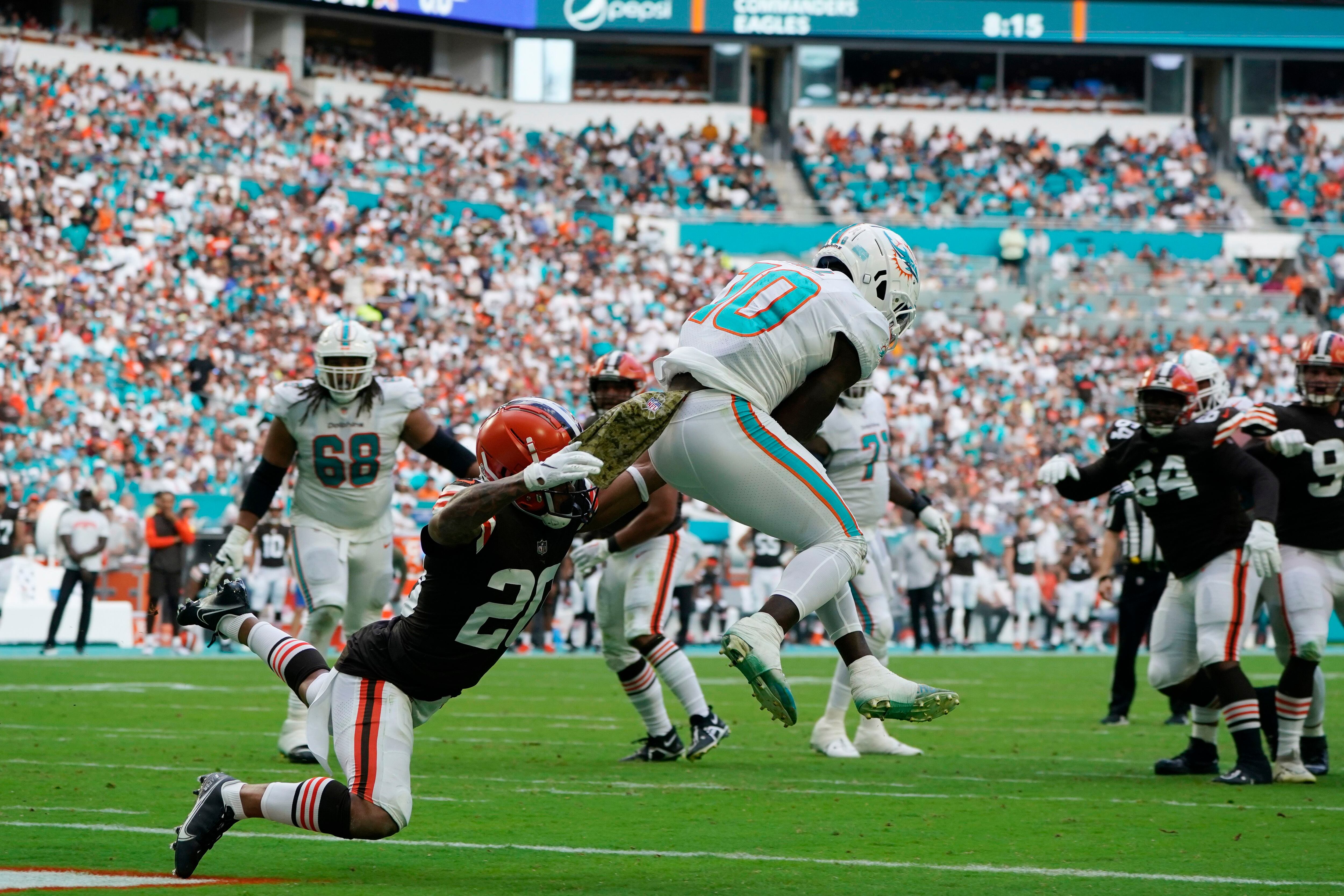 Cleveland Browns running back Nick Chubb (24) and Miami Dolphins wide  receiver Tyreek Hill (10) exchange jerseys at the end of an NFL football  game, Sunday, Nov. 13, 2022, in Miami Gardens