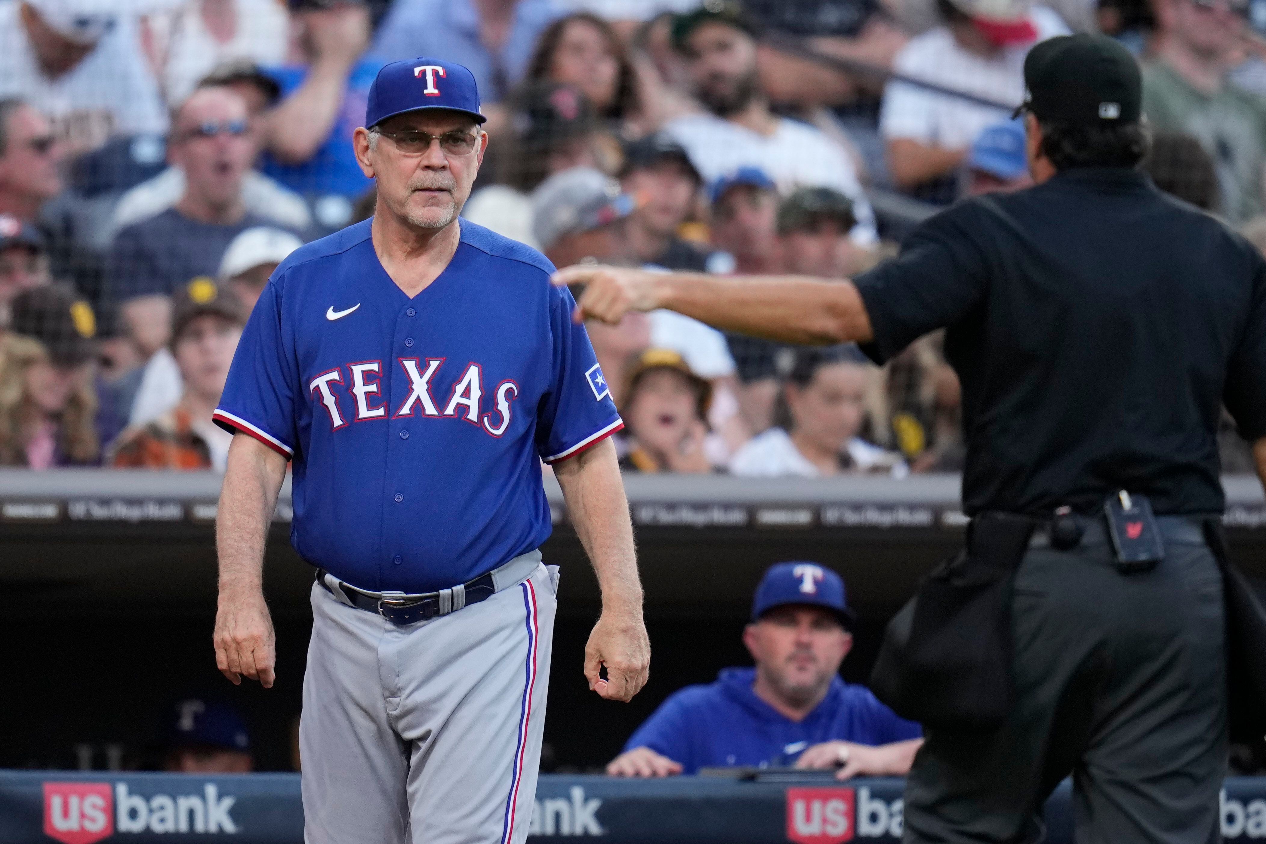 Now-former Washington Nationals' pitching coach Mike Maddux signs